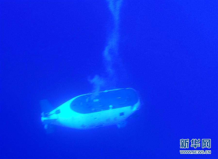 “蛟龙”号载人潜水器离开“向阳红09”科学考察船缓缓进入水中。
