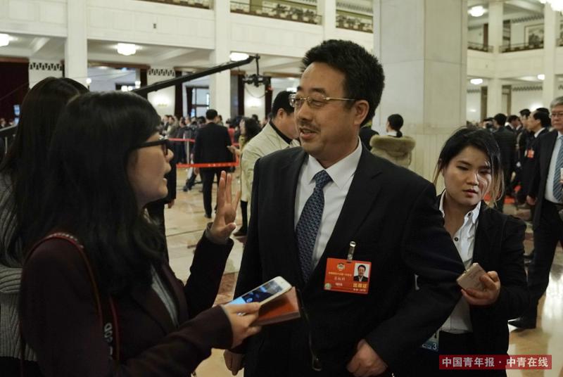 3月15日，北京人民大会堂，港珠澳大桥管理局总工程师苏权科在“委员通道”采访结束后继续回答记者提问。中国青年报·中青在线记者 赵迪/摄