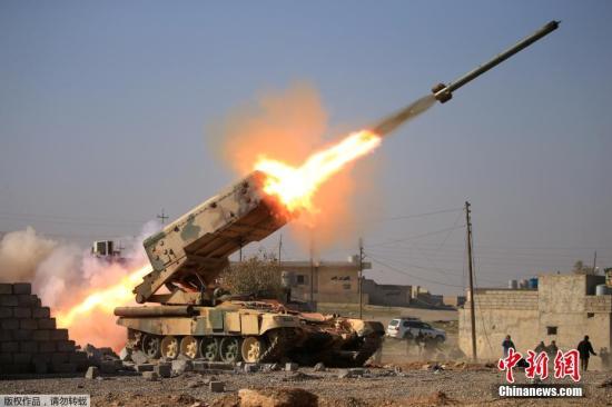 资料图：当地时间2月23日，在伊拉克摩苏尔被“伊斯兰国”控制的盖兹拉尼军营附近，政府军向“伊斯兰国”武装人员发射火箭弹。