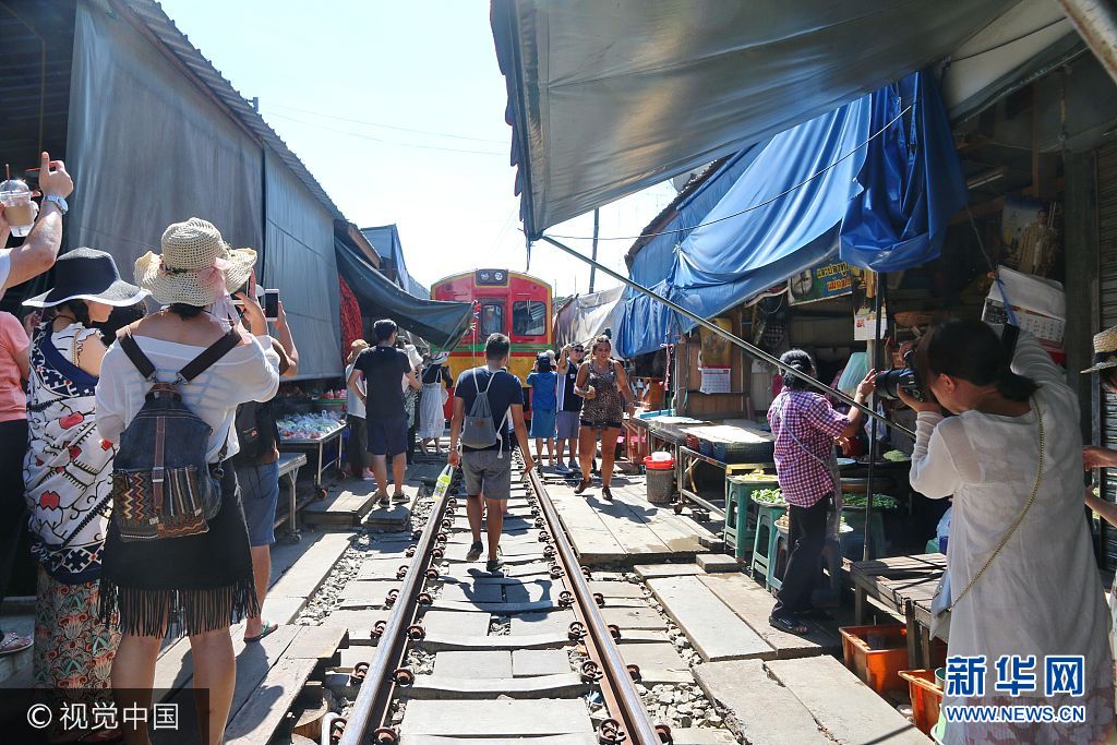 ***_***当地时间2017年9月9日，泰国夜功府，游客在美功菜市场等待列车到来。