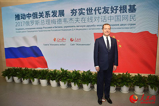 俄罗斯总理梅德韦杰夫在欢迎屏前留影